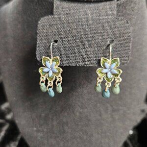 Silver tone flower shaped dangle earrings with green / blue accents